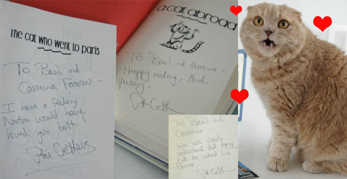 Autographed books from Peter Gethers or Russell Andrews, author and Random House Focus Features president. Cream yellow Scottish Fold, cute cat meowing with red hearts next to signed novels.