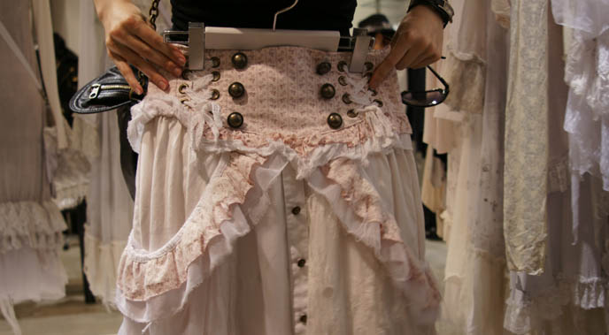 Pink and white skirt with buttons, high waist. Gramm collection, Gothic Lolita dresses, deconstructed faded asymmetrical lace pastel clothing, designer garments from Japan, Rococo skirts, avantgarde clothes from Tokyo, MaruiOne shopping complex or department store.