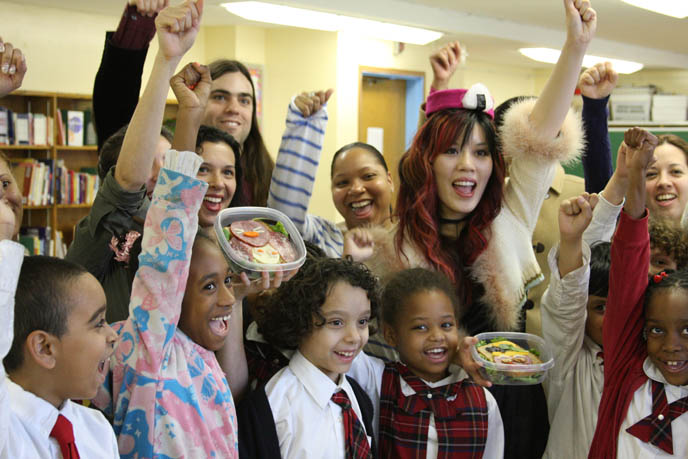 raising fists in air, hooray, cheesy tv show, TEACHING ELEMENTARY SCHOOL CHILDREN IN HARLEM HEALTHY EATING. JAPANESE CHARACTER BENTO LESSONS IN UNDERPRIVILEGED NEW YORK CLASSROOM. onigiri hat, phoenix wright cosplay, best cosplay outfits, harlem schoolchildren, kids in underprivileged school, cooking lessons, black skull scarf, silk black goth prom dress, TEACHING CHILDREN HEALTHY EATING HABITS, CUTE CHARACTER BENTO-MAKING AT HARLEM ELEMENTARY SCHOOL. pretty Asian model, Chinese idol girl, NHK TV, KAWAII BENTOS TV SHOW: LA CARMINA, BLOGGER & CUTE YUMMY TIME AUTHOR. filming japanese game show, charaben, CUTE CHARACTER BENTO, crazy FOOD COOKING SHOW, NHK JAPAN TV DOCUMENTARY SHOOT, NEW YORK WAVE