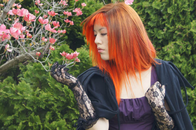 bright neon orange hair, emo girl hairstyle, la carmina, NEW ORANGE HAIR, SPECIAL EFFECTS BRIGHT ORANGE COLORFUL DYE, JAPANESE MODERN HAIRCUTS, pumpkin head hair, extreme hairstyles, avantgarde Tokyo, LACE GLOVES, black peace now VAMPIRE CAPE, gloomth dress