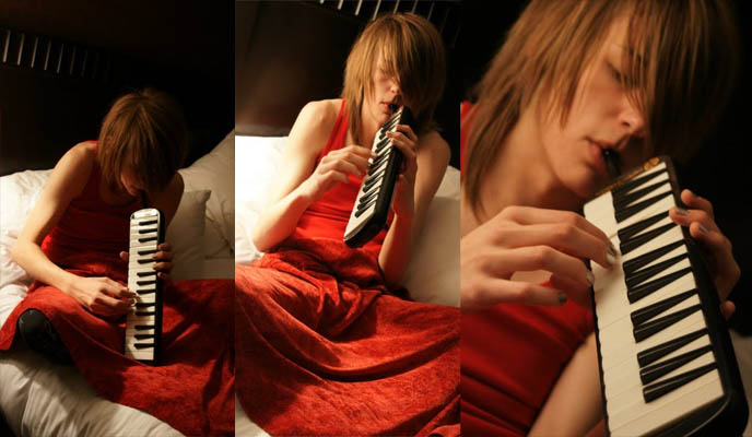boy playing Hohner melodica, student piano, blow organ reed instrument, keyboard with mouthpiece, weird instruments like accordion, blond teenage boy lying in bed, emo scene hair, visual kei boys, long hair girly boys, young men cute, visual kei, j-rock yaoi boyslove.